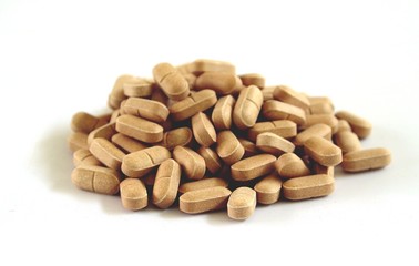 Heap of supplement tablets or herbal medicine in white background