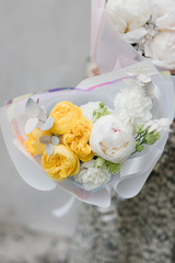 Girl holds a bouquet of flowers. Florist and a bouquet of flowers. Female hands and flowers. Flower shop concepts.