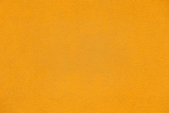 Rough saffron color textured wall background.