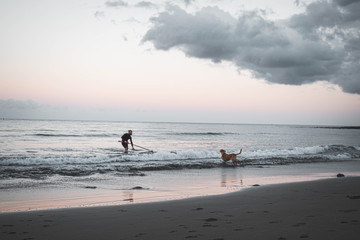 family walking on the beach at sunset
