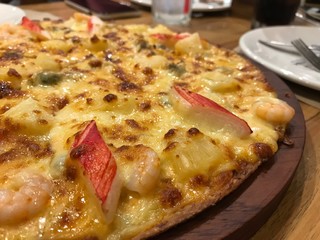 pizza with seafood and  cheese on the wooden tray background.