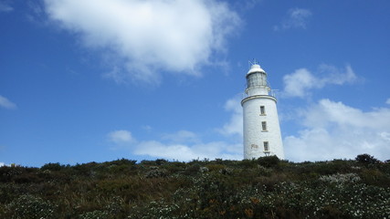 Lighthouse on blue sky background