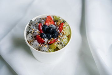 Fruity Acai smoothie Bowl. A bowl of Acai berry smoothie topped with kiwi, strawberry, berry and granola. A healthy snack.
