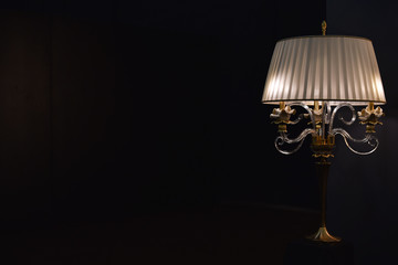 table lamp with bra in dark room