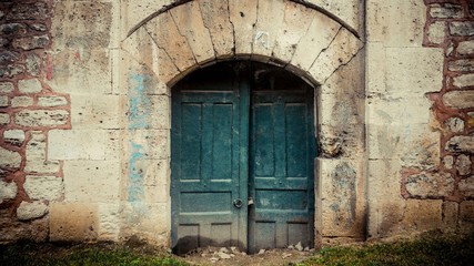Fototapeta na wymiar Blue wooden door with white brick walls