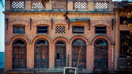 Brick of walls with rows of wooden door and windows