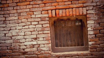 Fototapeta na wymiar Brick walls with a black bar of window