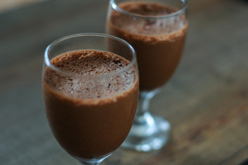 Chocolate foam dessert on wooden table.