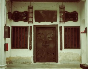 Brown metal door with brown window with grill