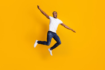 Full length body size view of his he nice attractive cheerful cherry guy jumping having fun weekend vacation free time isolated over bright vivid shine vibrant yellow color background