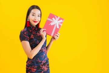 Portrait beautiful young asian woman wear chinese dress with red gift box