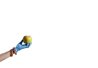 Hand in blue latex glove with bracelets holding an apple