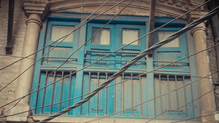 Green door with railing and aconcrete pillars