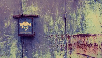 Green rusted wall with rough surface and small box