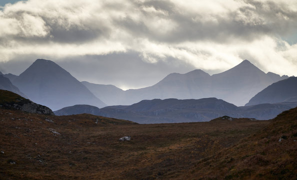 Distant views of cloud over the Torridon mountains from Loch Kernsary near Poolewe in the Scottish Highlands, Scotland, UK.