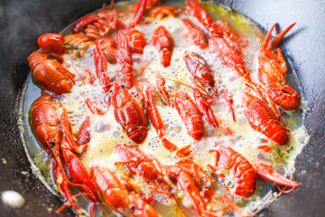 Chinese food with minced garlic and crawfish in the iron pot