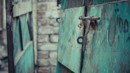 Lock pad on a green metal surface with graffiti