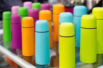 neon colored group of assorted thermoses