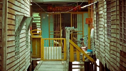 Orange gate with wooden wall with windows