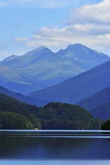 glacier lake at the mountain in summer time with clouds