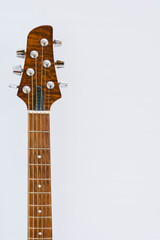 Acoustic guitar detail on white background copy space.