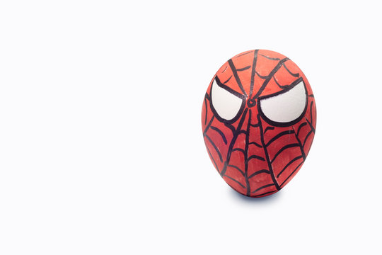 Cologne, Germany - April 13, 2020: Colorful painted spiderman Easter egg in isolated background