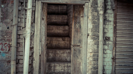 Sets of brown stairs and a wooden door