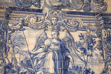 Fototapeta na wymiar beautiful hand painted azulejos tiles Obidos Portugal. Historic tile panel depicting a scene