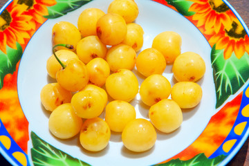 fresh tasty white cherries in the plate