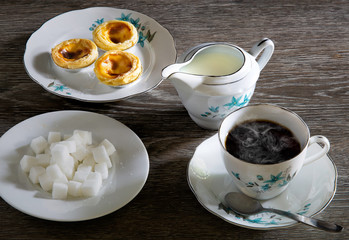 Hot tea style English and snack with sugar and fresh milk on gray wooden table