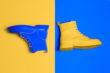 Yellow and blue boots. Top view flat lay. Creative footwear design concept.