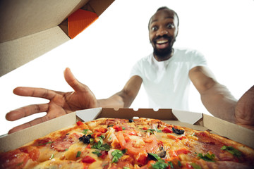 Amazing african-american man preparing unbelievable food with action, details and bright emotions,...