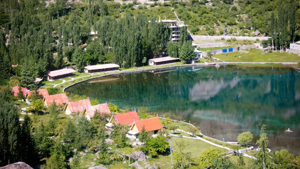 Fototapeta na wymiar Top view of houses and trees with big lake