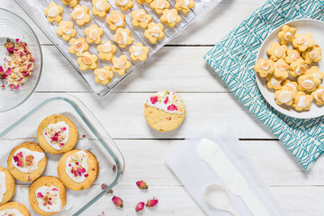 Home made rose short bread cookies on white wooden table top with copy space for text
