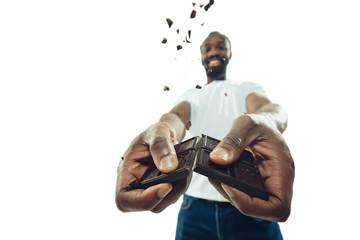 Amazing african-american man preparing unbelievable food with action, details and bright emotions,...