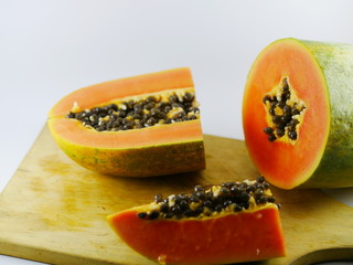 Carica Papaya L (papaya) fruits slice on the wood board.
