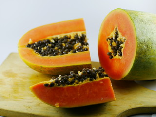 Carica Papaya L (papaya) fruits slice on the wood board.