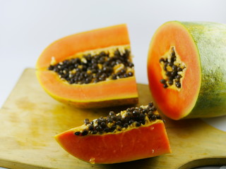 Carica Papaya L (papaya) fruits slice on the wood board.