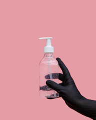 A hand in a black surgical glove holds a clear bottle of sanitizer with a dispenser - a necessary tool for hand dysinfection during the covid-19 pandemic. Pop art style.