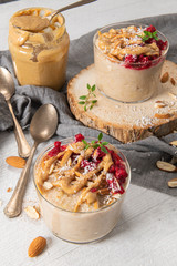 Breakfast oatmeal porridge with raspberries, almond, cinnamon, almond butter and coconut. Healthy breakfast delicious homemade english breakfast concept