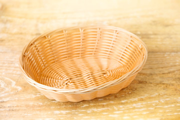 
Oval shaped wicker basket on a wooden table