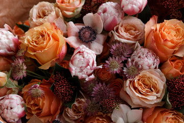 Orange and cream flowers background. Tulips, anemone, roses. Flower shop. Florist. Wallpaper.