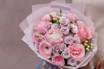 Spring pastel bouquet with roses closeup. Pink peony, ranunculus, roses. Flower shop. Flower wallpaper. Background.