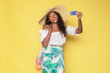 Tanned woman enjoying her summer vacation using a credit card