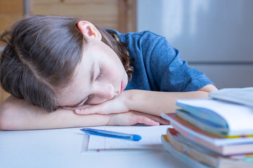The child fell asleep from boredom while doing homework
