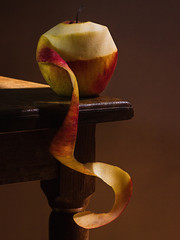 Juicy green red apple, on a wooden table, with a dark background, soft light. Imitation of a Dutch kitchen still life. Mono food. - 351550150