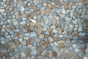Texture of masonry from rubble of gray and brown diorite volcanic rock