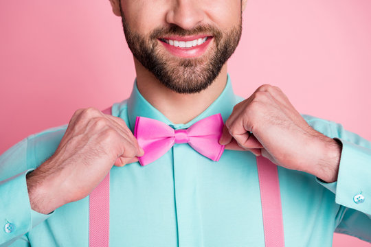 Close-up cropped view portrait of his he nice attractive content metrosexual elegant cheerful cheery imposing luxury brandy bearded guy artist fixing bow isolated over pink pastel color background