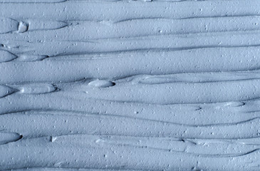 Gray bentonite facial clay (alginate mask, face cream, body wrap) texture close up, selective...
