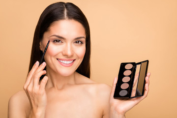 Close-up portrait of her she nice-looking attractive lovely charming cheerful cheery brown-haired woman using rouge powder base concealer isolated over beige pastel color background